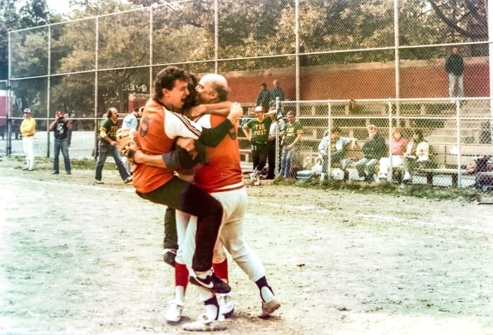 McMane (right) and UPI teammate Joel Sherman celebrate winning the 1984 title over the Post (for whom Sherman is now a baseball columnist) at the league's alternate field on 54th St. and 11th Ave.